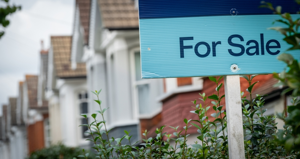 For sale sign outside a row of houses