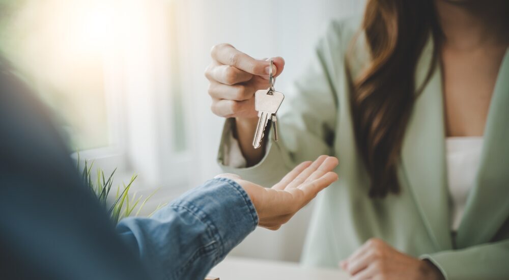 Buying a House Solicitor handing over house keys to client.