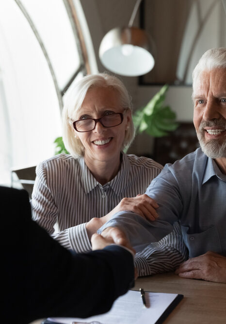 Man in couple shaking hands with solicitor.